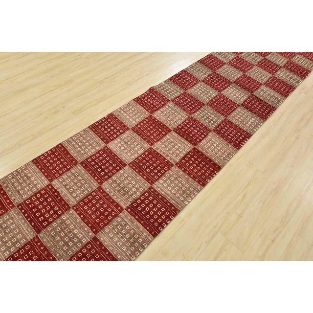 A contemporary Gabbeh runner hand-knotted with fine wool on a cotton foundation. This runner features a chequered pattern...