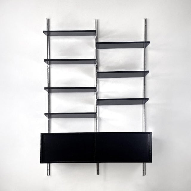 Italian modern black wood and metal bookcase E22 by Borsani for Tecno, 1970s Wall bookcase mod. E22 in wood and metal. It...