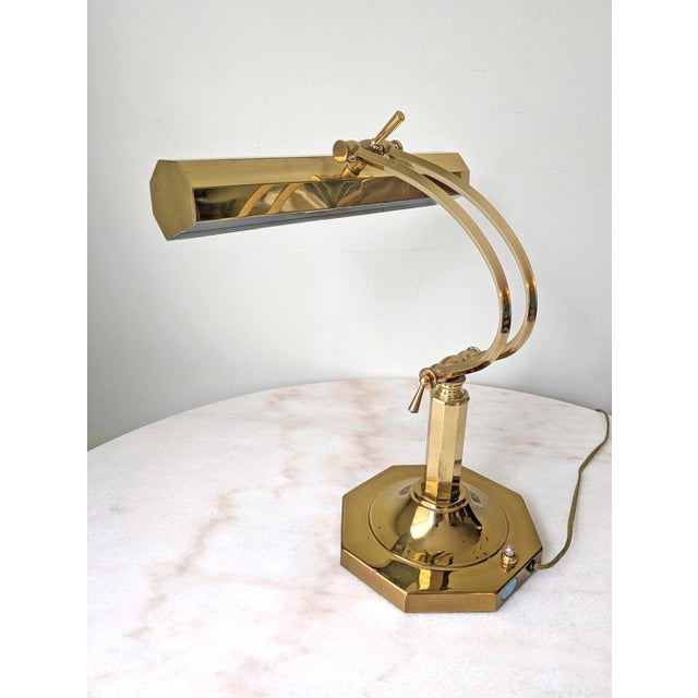 A vintage brass table lamp boasting a classically elgant design. Original wiring tested and in good working condition....