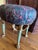 This elegant vanity stool features a plush, pleated seat upholstered in a vibrant, multi-color paisley fabric. The piece...