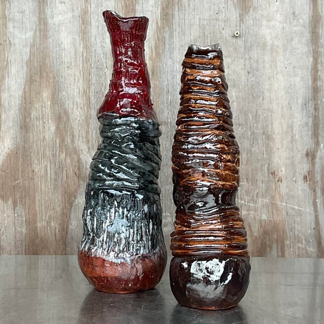 A fantastic pair of Boho Studio pottery vases. Beautiful hand made pieces in beautiful warm colors. Signed by the artist....