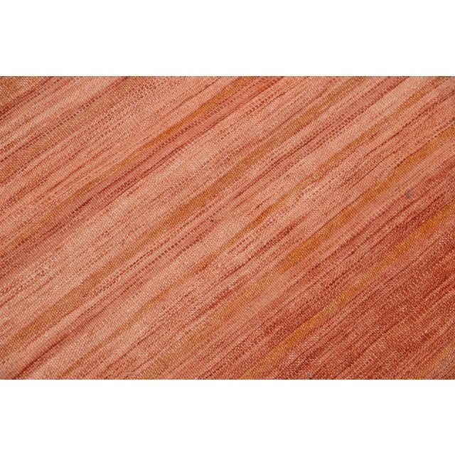 Beautiful Vintage Kilim hand-knotted wool runner with a red color field. This rug has beige accents in an all-over...