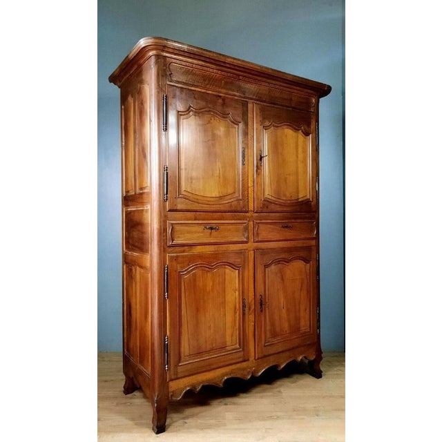 Louis xv period walnut four-door cabinet louis xv period walnut four-door cabinet, circa 1750. The front features four...