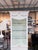 White painted curio cabinet featuring tall glass paneled doors, interior display shelves, and a decorative crown with...