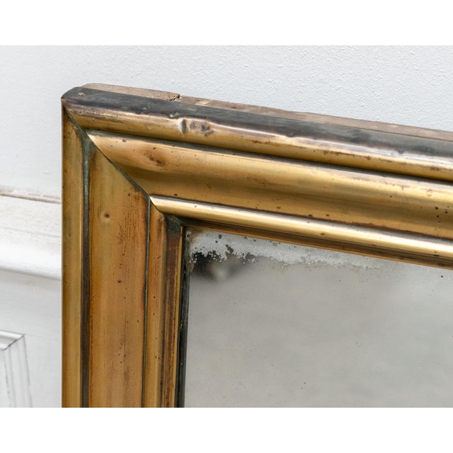 Beautiful antique brasserie mirror dating from the 19th century, with its wide brass frame boasting a naturally rich...