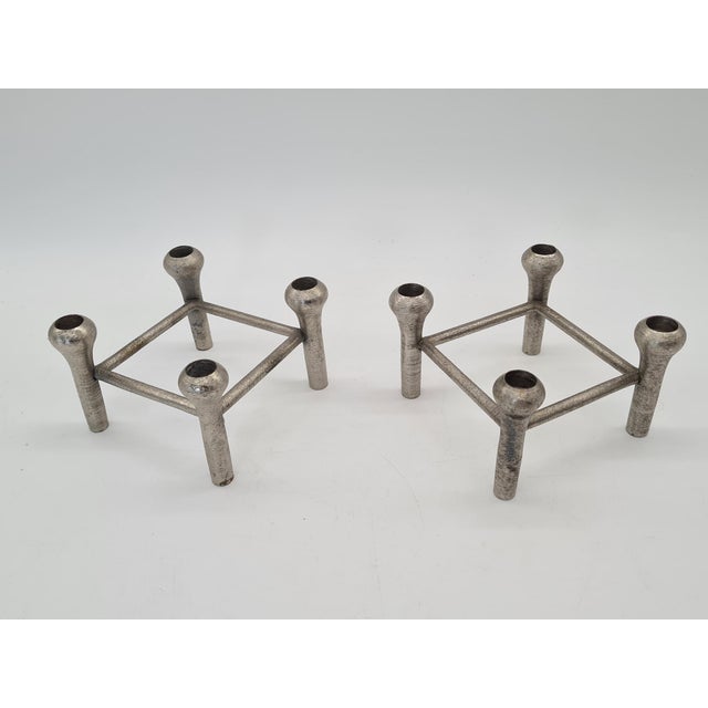 An original set of two modular candlesticks made of cast aluminum, dating from the 1970s–1980s. Their minimalist,...