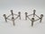 An original set of two modular candlesticks made of cast aluminum, dating from the 1970s–1980s. Their minimalist,...