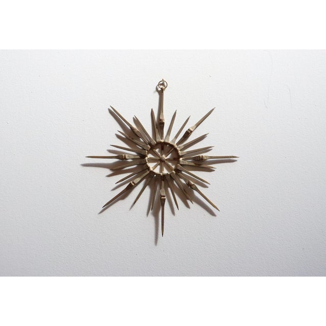 Small vintage horseshoe nail star-form ornament/wall sculpture in mixed metals including brass with gold leaf...