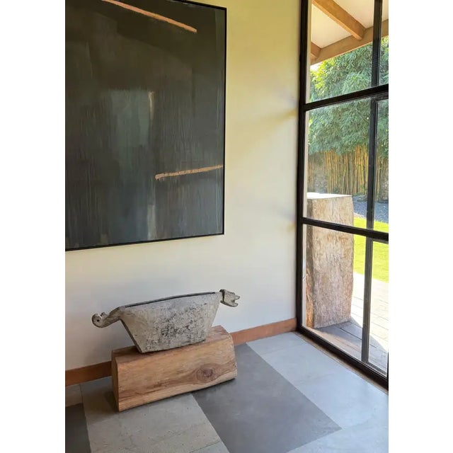 This striking kentongan slit drum from Java is masterfully carved from a single piece of dense hardwood, shaped in the...