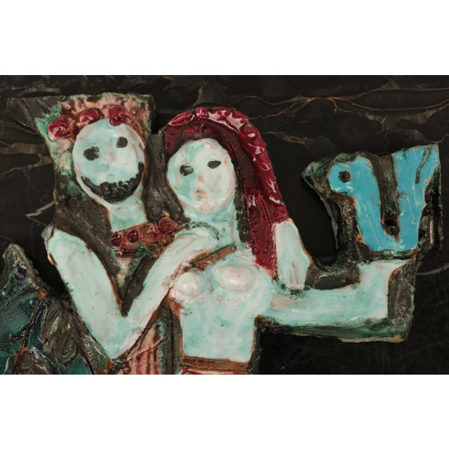 Mid century pottery plaque titled "David and Bathsheba". This piece features aqua tones and was created by renowned...