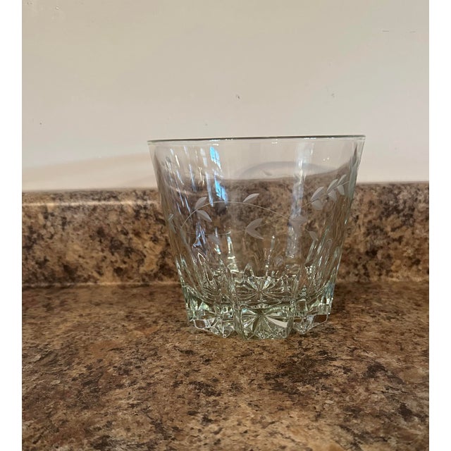 Beautifully etched glass piece with a leaf and vine design and a faceted base. This versatile item can serve as an ice...