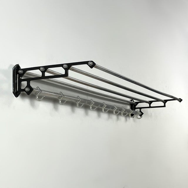 Wall coat rack in art deco style from the 1950s, made of iron and aluminium and equipped with 8 sliding hooks on a square...
