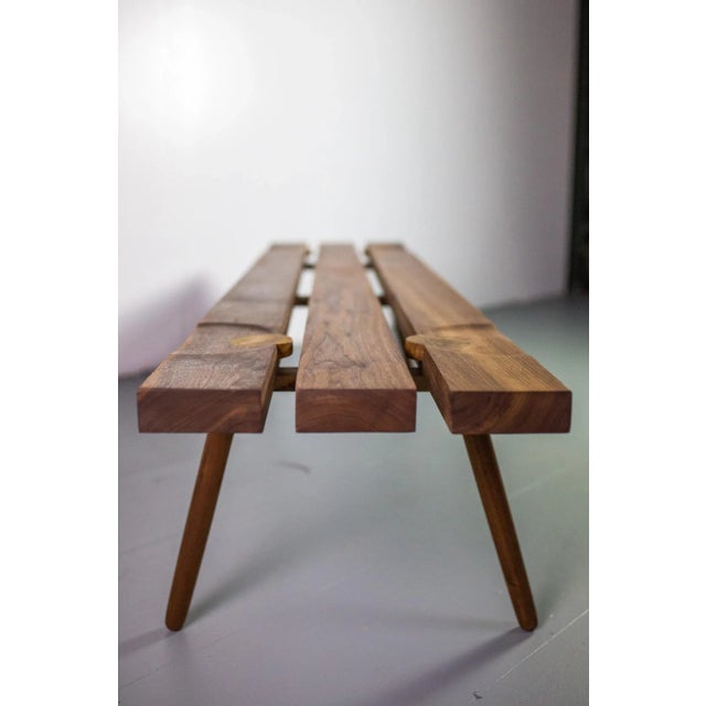Studio Slat bench by Michael Rozell USA 2020 in walnut and white oak inlays. This piece is attributed to the mentioned...