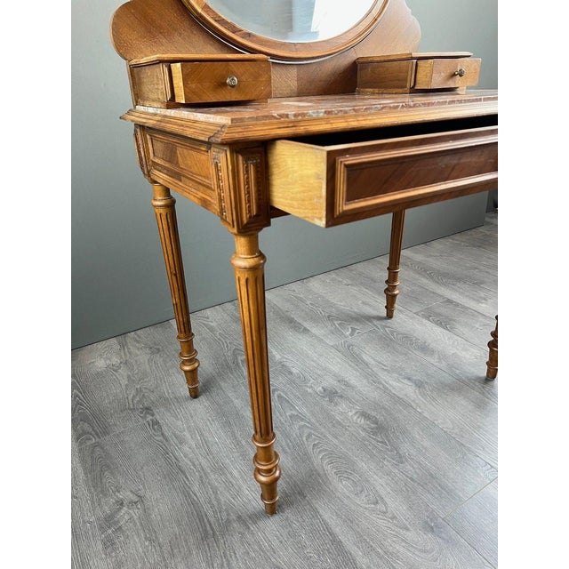 Charming Louis XVI style dressing table in light wood, dating from the late 19th century. It features an elegant oval,...