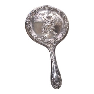 Silverplated Hand Mirror Decorated With a Cherub For Sale