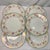 Offered here are vintage porcelain plates featuring a pink rose floral border with ornate gold and green trim, classic...