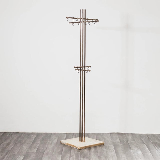 A refined and iconic freestanding coat rack, attributed to the collaboration between renowned designer renato zevi and...