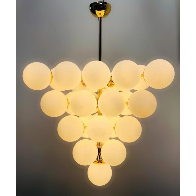 Italian chandelier with matte white Murano glass globes mounted on polished brass finish frame / Made in Italy by Fabio...