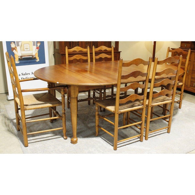 This set features warm cherry wood with a classic colonial profile, shown in the oval tabletop and turned legs. The...