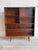 This beautiful open-face Bookcase displays a minimalist tall silhouette raised on round tapered legs. The architectural...
