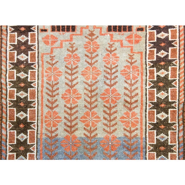 A wonderful early 20th century Persian Afghani Baluch prayer rug with a charming floral and vine pattern running the...