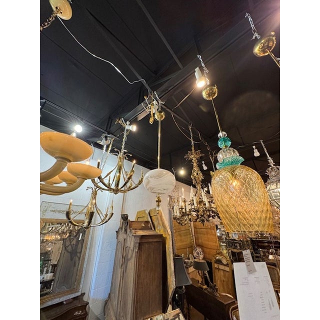 The Murano Glass Globe Pendant is a stunning decorative light fixture. Featuring white Murano glass with a swirling gold...