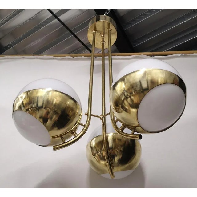Simple but original Murano glass and brass chandelier, elegant and unique design. The chandelier is composed of a brass...