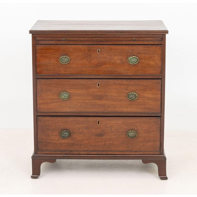 American Federal Walnut Chest of Drawers, circa 1800, with pull-out writing surface above three drawers atop bracket feet....