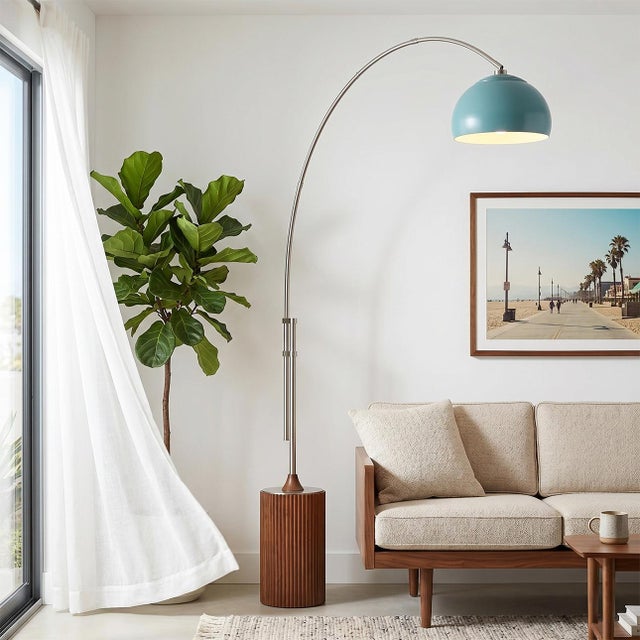 Satin Nickel steel paired with a Dark Walnut wood base defines the Tambo Arc Lamp, a Mid-Century Modern masterpiece...