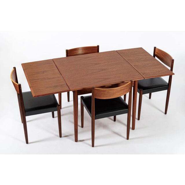 This lovely vintage mid century Danish modern extendable teak dining table and dining chair set was designed by Poul...