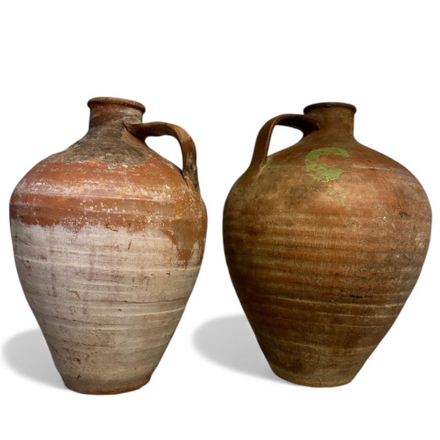 A pair of rustic jugs sourced from Holly Hunt, Chicago. Beautiful texture, glazed with earth tones. Beautiful accent...