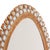 An elegant oval mirror featuring a sculptural gilt resin frame accented with rich blue glass elements, inspired by the...
