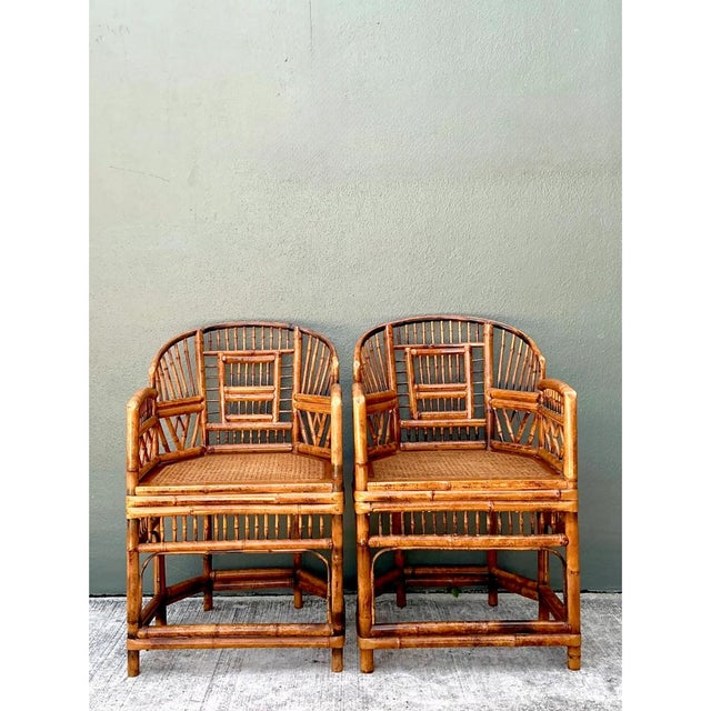 This pair of vintage rattan Brighton Pavilion-style lounge chairs exemplifies the exuberant, Chinoiserie-inspired design...