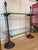 Cast iron bistro shelf with 2 glass shelves, finials and wide base feet. Over all height 26.5" Height to lower shelf 7.5"...