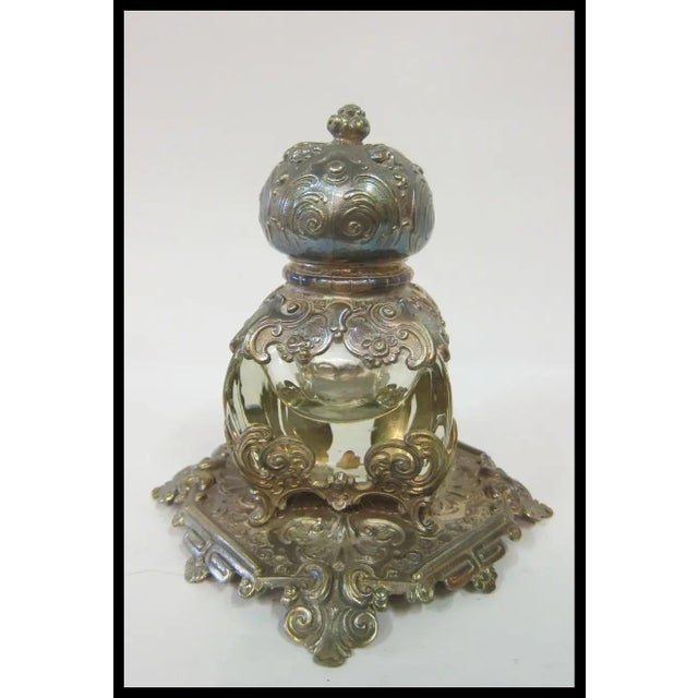 A stunning French inspired silver-plated inkwell designed with elaborate scrolling. Detailed decorations accent & enhance...