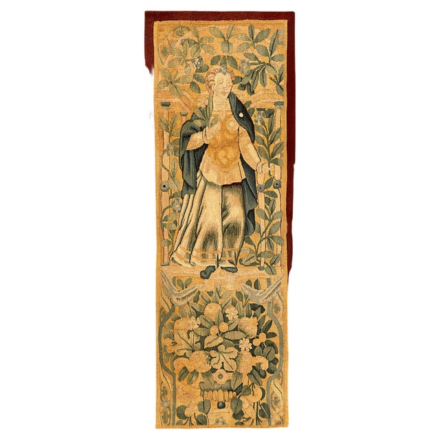 A 17th century Flemish Historical Tapestry panel. This vertically oriented decorative tapestry panel depicts a regal...