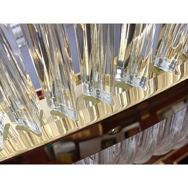 Impressive chandelier in gold 24k and clear triedrons. a jewel of hight italian craftmanship. luxury chandelier for modern...