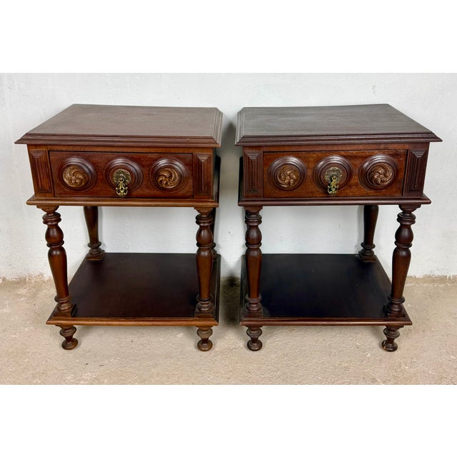 Attractive pair of Spanish nightstands crafted in carved wood, featuring a single drawer, turned supports, and a practical...