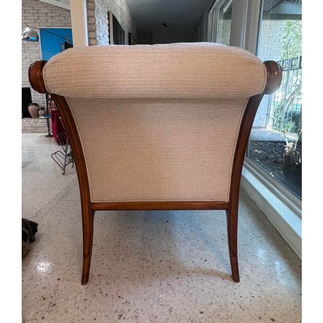 A striking vintage Klismos-style chaise lounge featuring a sculptural walnut frame and graceful, classically inspired...