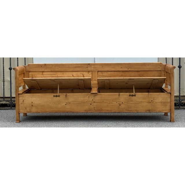 This massive bench , over eight feet long, has two storage compartments, each accessed by a 42” wide hinged lid. The long...
