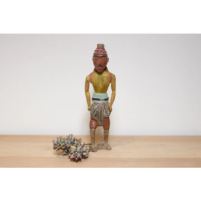 Charming antique carved wood figure of a Rajasthani warrior, dating back to the 19th century. This captivating piece...
