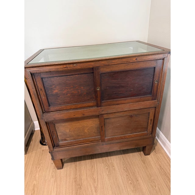 Striking early 20th-century oak and glass mercantile display cabinet or store showcase, dating approximately to the early...