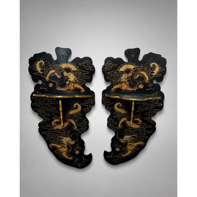 A rare and unusual pair of Japanese Meiji period lacquered folding wall shelves, likely late 19th century, each formed...