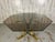 Brass, burl, & smoked octagonal shaped glass dining table in the style of Mastercraft, Lotus design with four curved brass...
