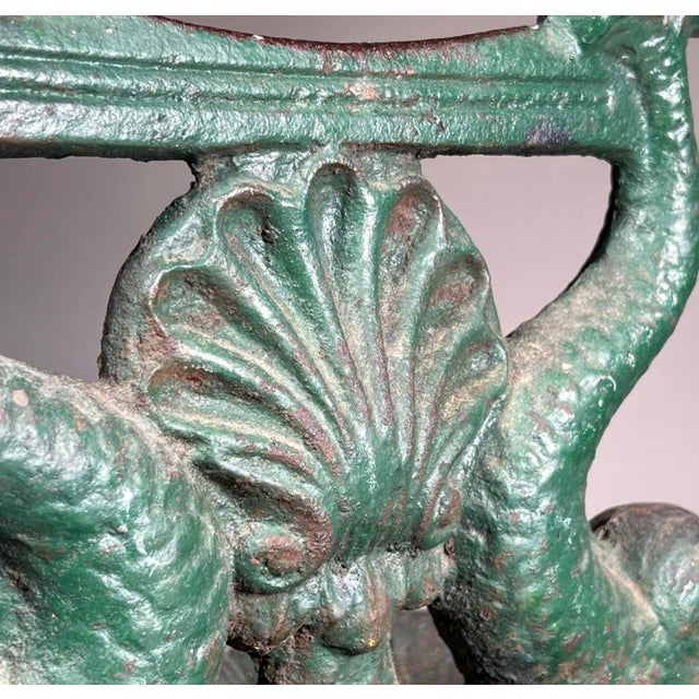 19th century cast-iron boots, scrape, and dolphin form with lovely verdigris finish.