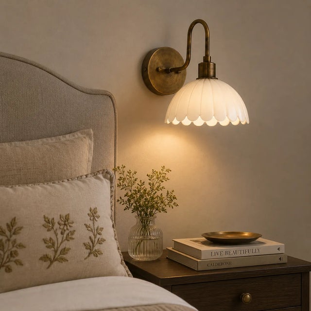 Bring warm, refined character to your interior with this handcrafted brass wall sconce, featuring a softly curved brass...