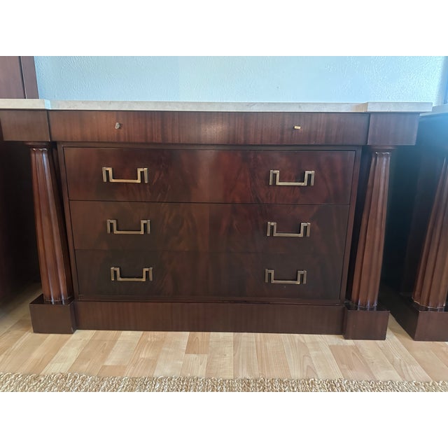 An exceptional pair of Baker Furniture three-drawer chests, distinguished by their commanding architectural proportions,...