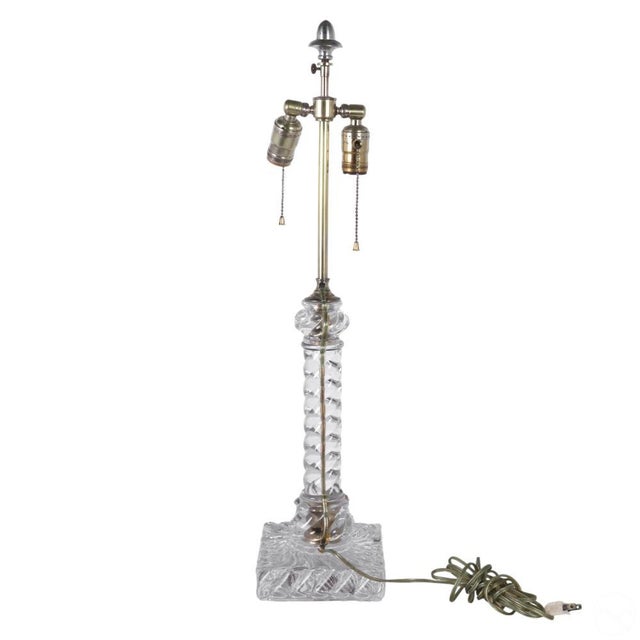 A 20th-century Baccarat-style crystal art glass table lamp with a twisted "Bambous" design. The base and stem feature...