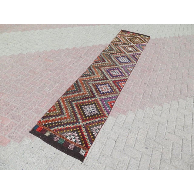 This beautiful, traditional vintage, flatweaved Turkish kilim rug is approximately 60 years old. It is handmade of very...