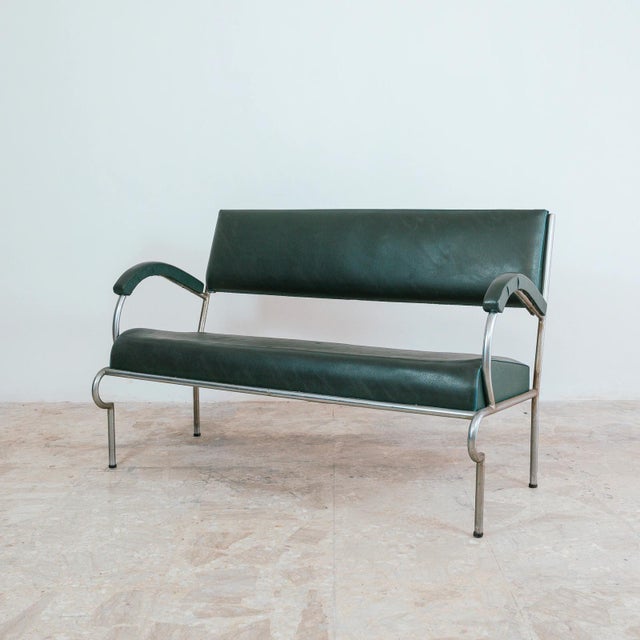 A rare and charming original vintage two-seater sofa, a superb example of industrial design dating back to the 1940s and...